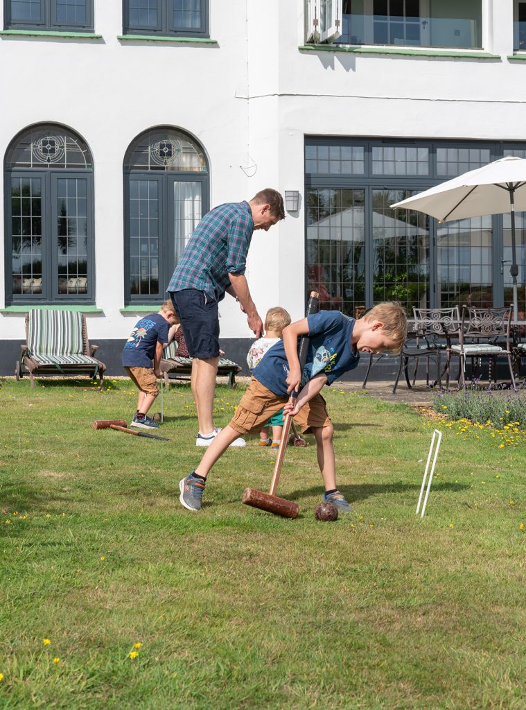 Family in the garden Family playing croquet in the garden