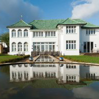 Art Deco House with view of pond in front